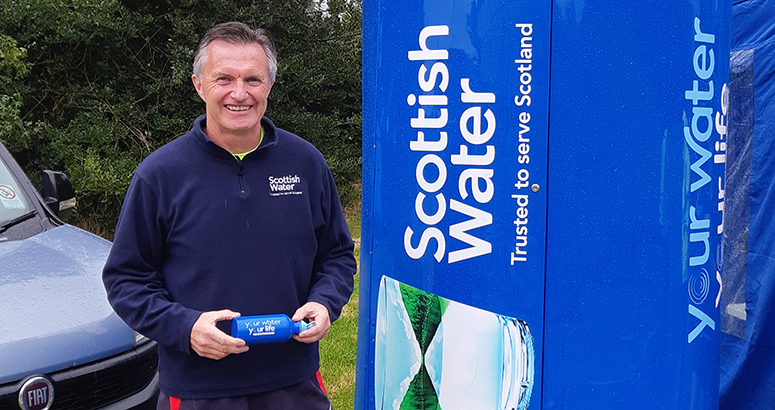 Man holding Scottish Water bottle
