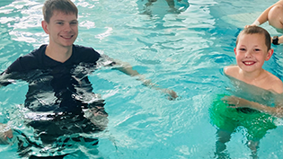 Young Jack Clews in the pool with Learn To Swim teacher Nathan McKechnie during an ASN class