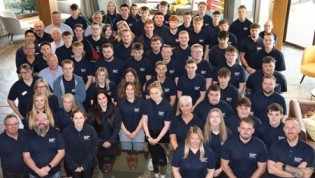 Scottish Apprenticeship Week 2025 Group of people in matching Scottish Water branded polo shirts posing for a photo indoors