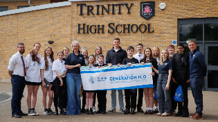 Trinity High School Celebrates Generation H₂O Challenge Win Group photo of students and staff standing outside Trinity High School holding a banner that reads 'Scottish Water - We won the Generation H₂O Making Waves Challenge'. Everyone is smiling and facing the camera.