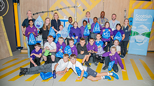 A young girl and boy, pupils from St Pius Primary School in Dundee,  busy with a water experiment at Scottish Water Generation H2O Water cycle workshop 