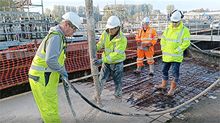 construction workers pouring concrete