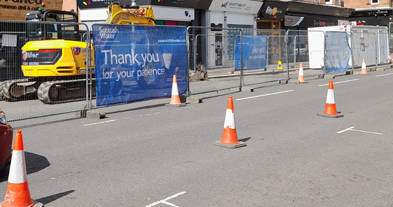 Sewer repair generic Busy street view showing a fenced off sewer repair works site with Thank You for Your Patience signage