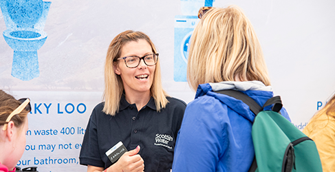 Female Scottish Water staff member talking to a woman and young girl