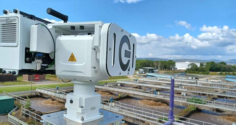 A picture of technology installed at a waste water treatment works. There are blue skies with some cloud, and grass in the background.