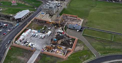 An aerial view of the site showing work taking place. A number of work vehicles are shown